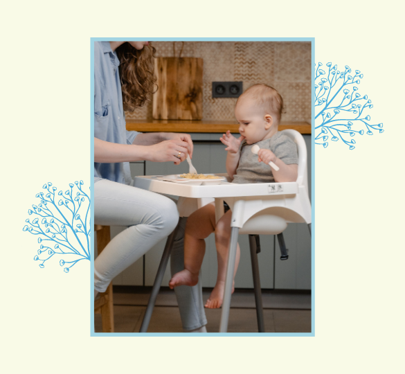 mom feeding baby on highchair