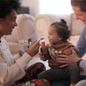 mother and father introducing solids to weaning baby