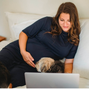 pregnant mom watching breastfeeding education video on laptop